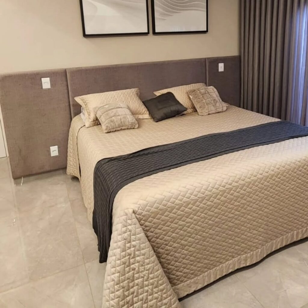 Detalhe de cabeceira de cama reformada em tecido premium pela Magnífico Estofados. Exemplo de tapeçaria fina para dormitórios de luxo, com foco no acabamento lateral e ajuste perfeito ao mobiliário do quarto.